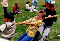 Boys pulling rope in tug of war, boy in yellow shirt C.1987/88