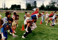 Piggyback races outside on a field for Sports Day activities C.June 1987