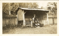 Photo of Robert Struthers as a child sitting with a dog. Likely shot in the early 1920