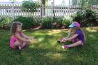 Two girls playing egg toss during Heritage Thursday