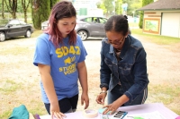 Museum Assistant Rebekah assisting a child with her craft.