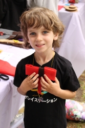 A little boy showing off his bow-tie craft