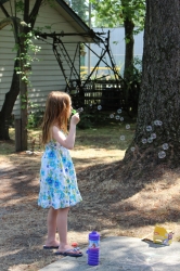 A little girl blowing bubbles
