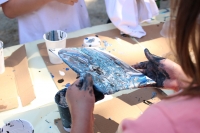 A child making an acrylic pour painting