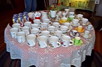 Cups and mugs all lined up for the Volunteer/Member Holiday Tea