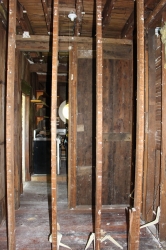 A photo shot from the main floor of the house looking from a bedroom through to the kitchen